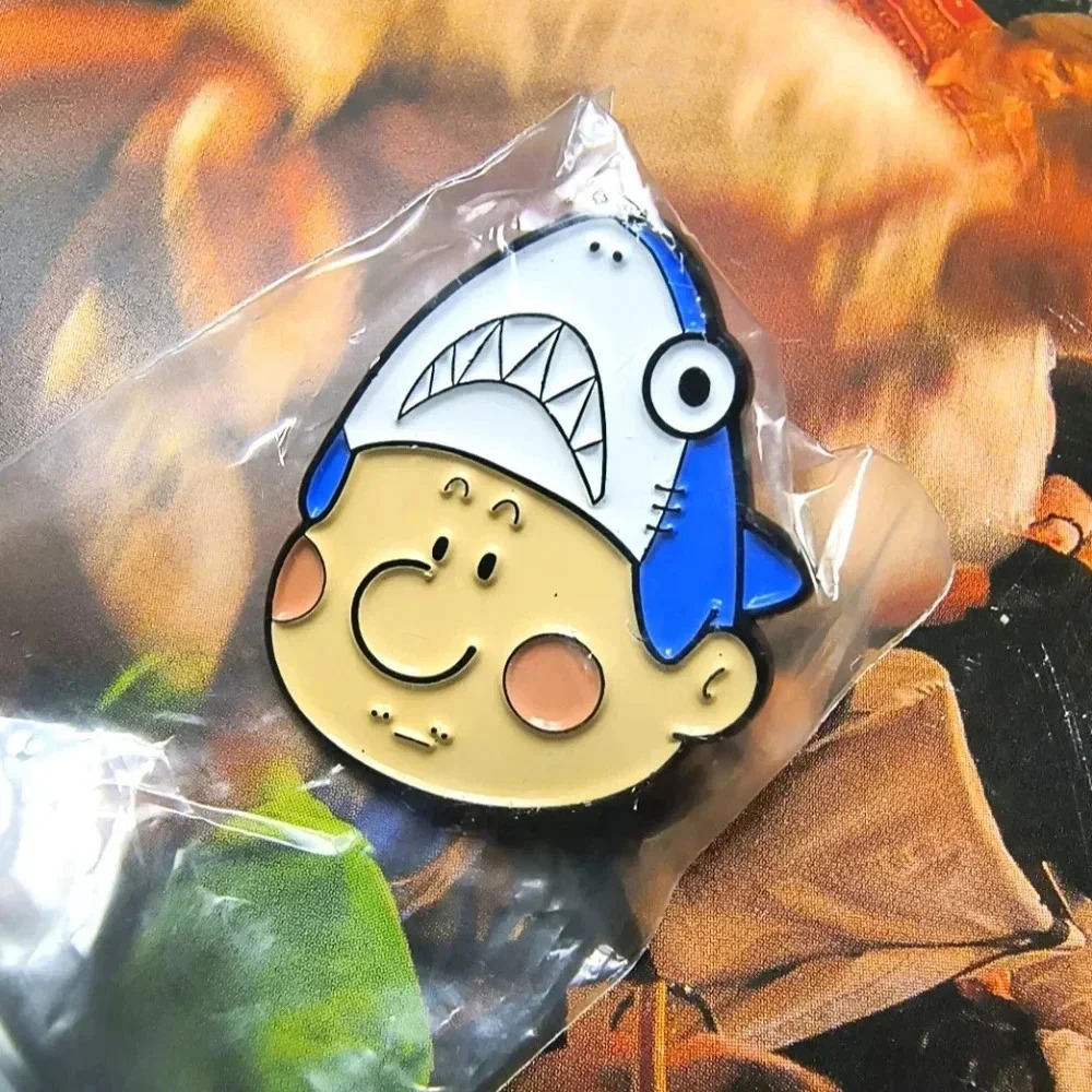 Guy wearing blue white shark hat enamel pin backpack clothes denim hat bag cap